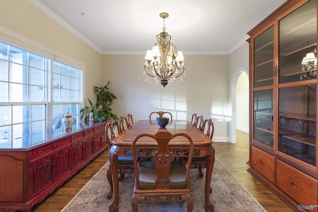 1033 Edgewood Cir, Arab, AL 35016 - dining area with a chandelier, arched walkways, wood finished floors, and ornamental molding