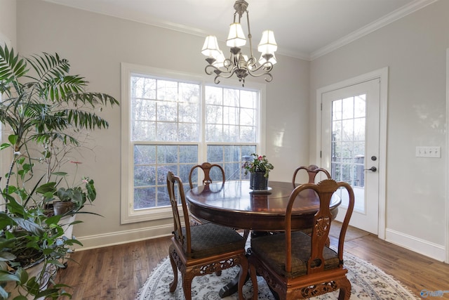 1033 Edgewood Cir, Arab, AL 35016 - dining space featuring dark wood-type flooring, a chandelier, baseboards, and ornamental molding