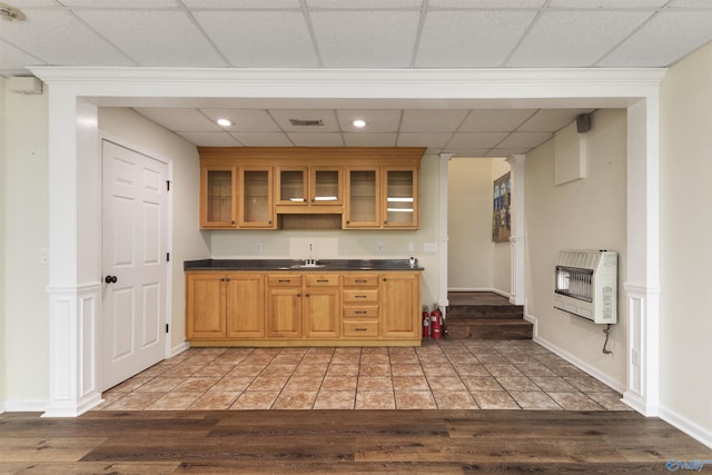 1033 Edgewood Cir, Arab, AL 35016 - kitchen featuring light wood-style floors, glass insert cabinets, dark countertops, a sink, and heating unit