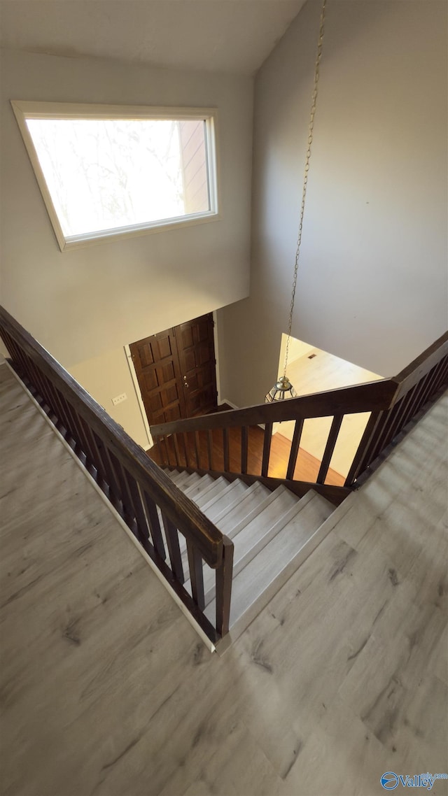 stairs featuring hardwood / wood-style floors