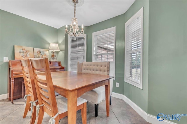 dining room featuring tile patterned flooring and an inviting chandelier