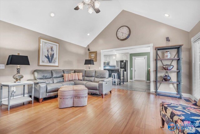 kitchen with a breakfast bar, stainless steel appliances, a kitchen island, decorative backsplash, and cream cabinetry