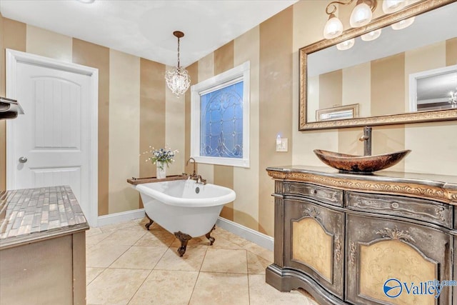 bathroom with vanity, tile patterned flooring, and a bathing tub