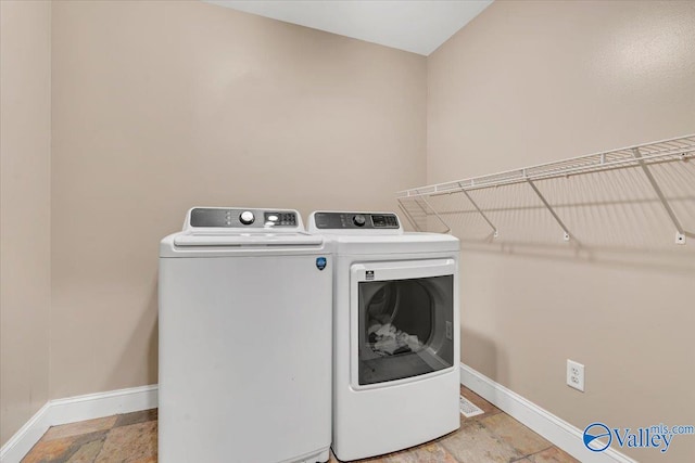 clothes washing area with washing machine and dryer