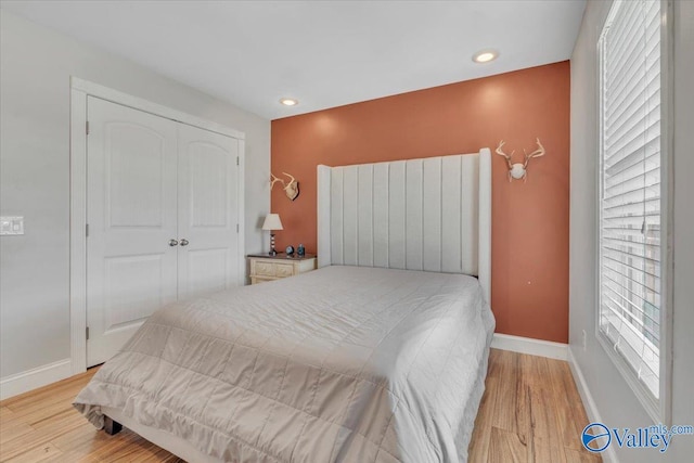 bedroom featuring light hardwood / wood-style flooring and a closet