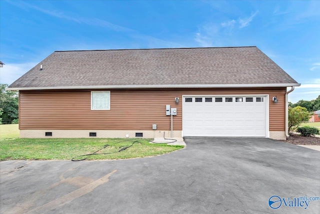 view of side of property with a yard and a garage