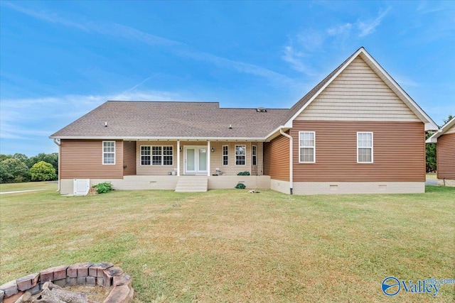 rear view of house with a yard