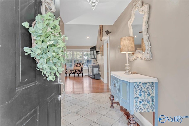 tiled foyer featuring lofted ceiling