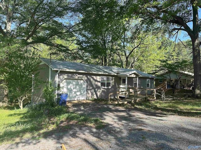 ranch-style house featuring driveway and a garage