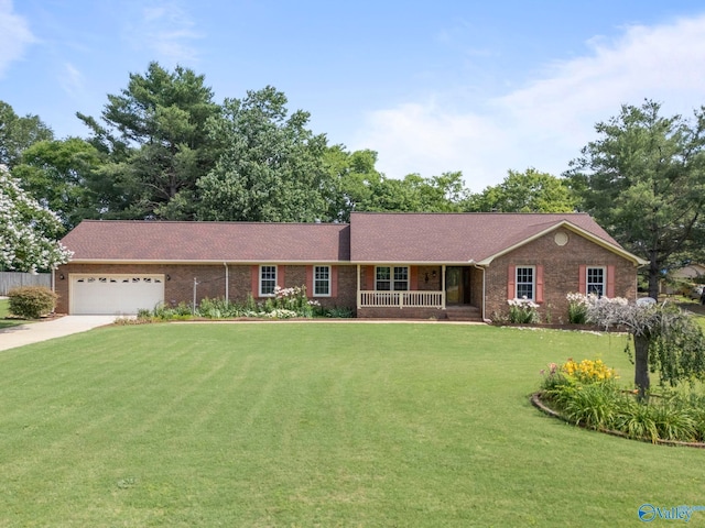 114 Butch Cir, Hazel Green, AL 35750 - ranch-style house featuring a porch, a front yard, a garage, brick siding, and driveway