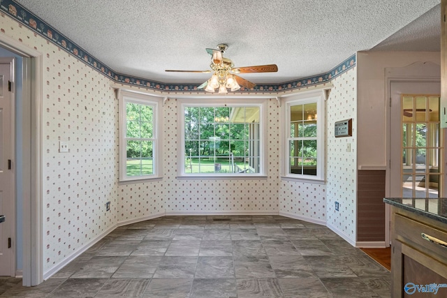 114 Butch Cir, Hazel Green, AL 35750 - unfurnished dining area with wallpapered walls, ceiling fan, and a textured ceiling