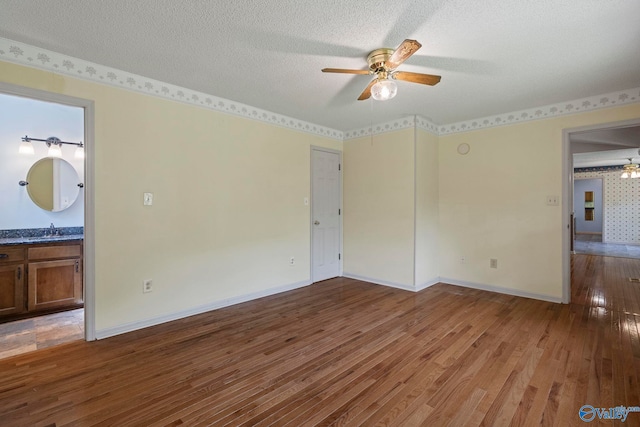 114 Butch Cir, Hazel Green, AL 35750 - spare room with a ceiling fan, wood finished floors, and a textured ceiling