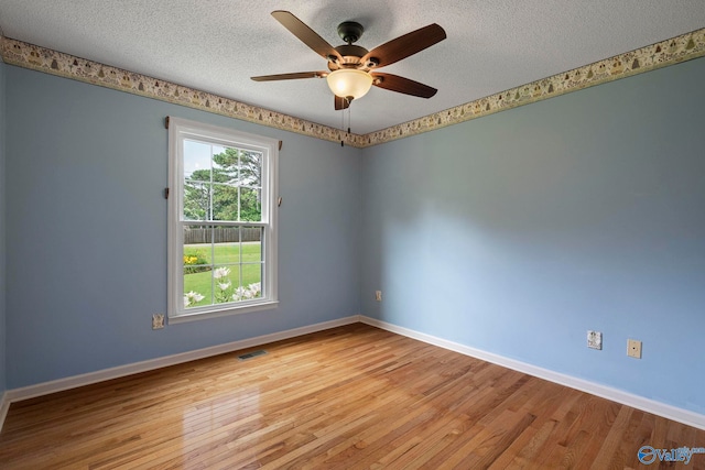 114 Butch Cir, Hazel Green, AL 35750 - spare room with a textured ceiling, light wood finished floors, and a ceiling fan