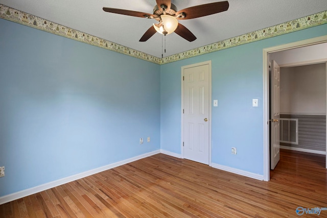 114 Butch Cir, Hazel Green, AL 35750 - unfurnished bedroom with wood finished floors and ceiling fan