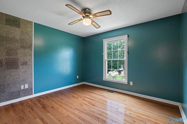 114 Butch Cir, Hazel Green, AL 35750 - empty room featuring wood finished floors, a ceiling fan, and a textured ceiling