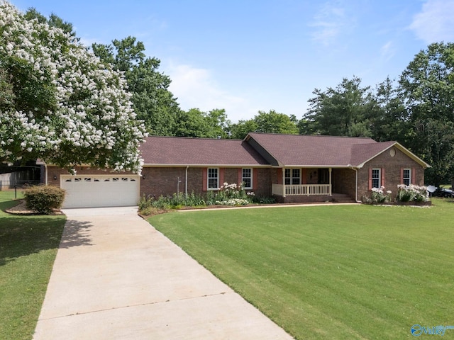 114 Butch Cir, Hazel Green, AL 35750 - ranch-style home with covered porch, a front yard, brick siding, and driveway