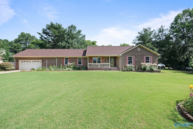 114 Butch Cir, Hazel Green, AL 35750 - single story home featuring a front lawn, a garage, brick siding, covered porch, and driveway