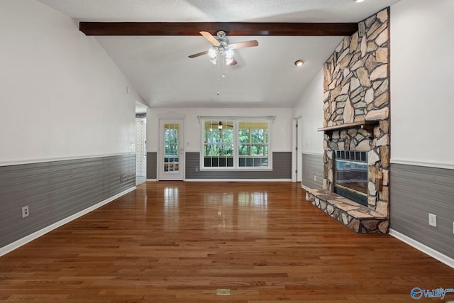 114 Butch Cir, Hazel Green, AL 35750 - unfurnished living room featuring a wainscoted wall, a fireplace, a ceiling fan, wood finished floors, and wooden walls