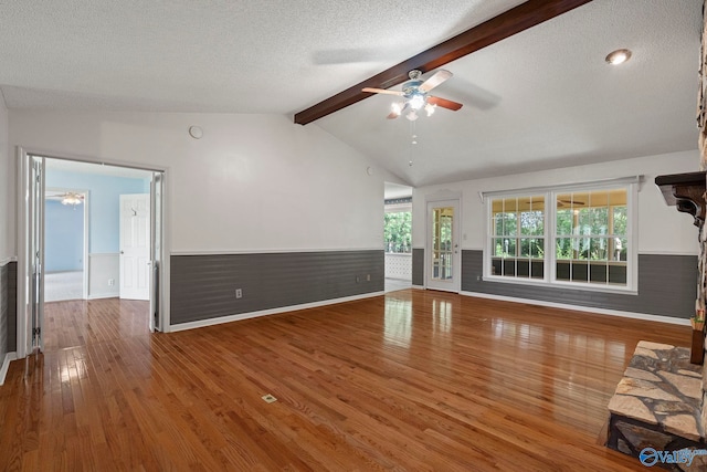 114 Butch Cir, Hazel Green, AL 35750 - unfurnished living room with ceiling fan, wainscoting, wood finished floors, and a textured ceiling