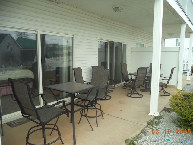 view of patio / terrace featuring outdoor dining area and fence
