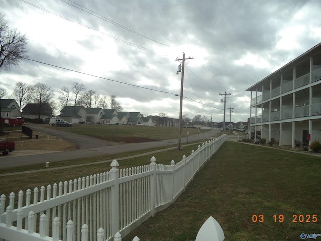 exterior space featuring a residential view and a fenced backyard