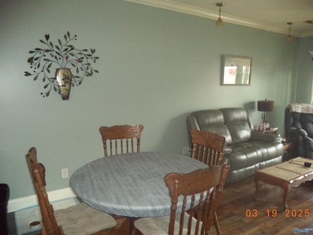 dining area featuring crown molding and wood finished floors