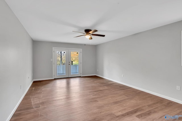 spare room with french doors, light wood-type flooring, and ceiling fan