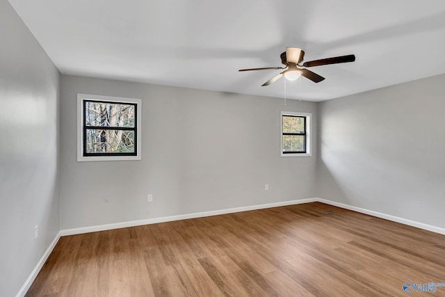 spare room featuring light hardwood / wood-style flooring and ceiling fan