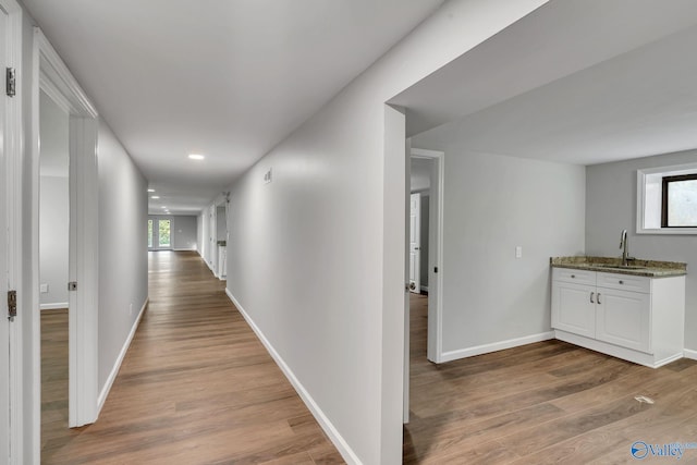 hall featuring sink and wood-type flooring