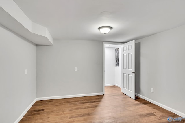 unfurnished room with hardwood / wood-style floors