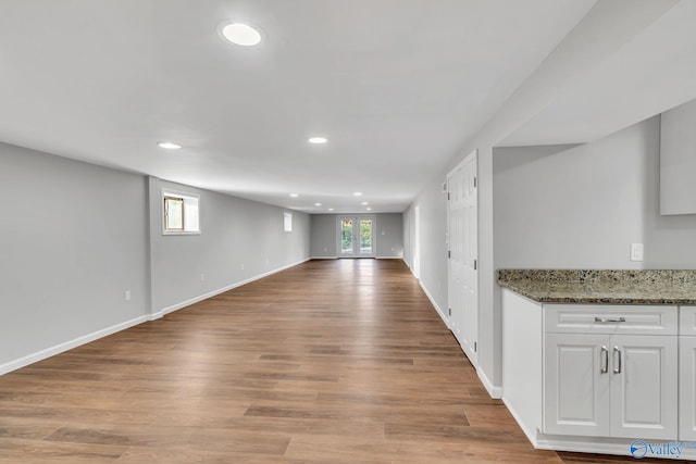 basement with light hardwood / wood-style flooring