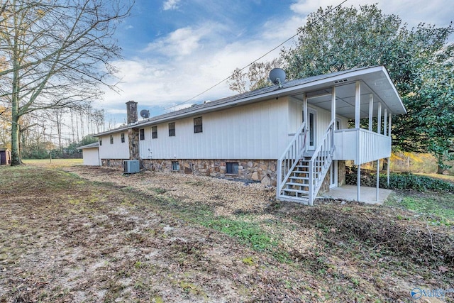 rear view of property featuring central air condition unit