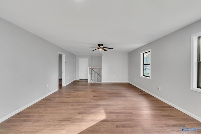 unfurnished living room with light hardwood / wood-style flooring and ceiling fan