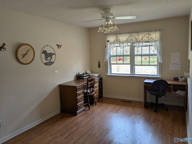 office area featuring ceiling fan, a textured ceiling, baseboards, and wood finished floors