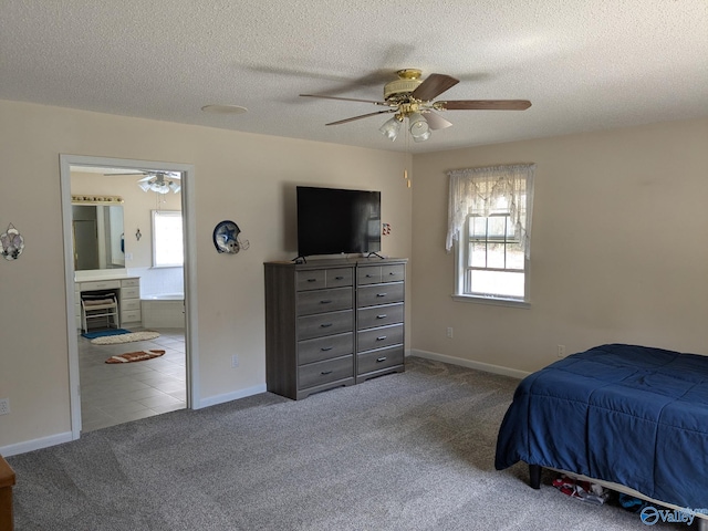 carpeted bedroom featuring baseboards, connected bathroom, ceiling fan, a textured ceiling, and a fireplace