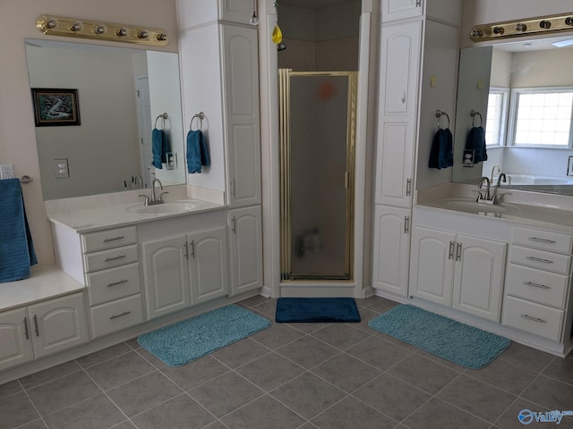 bathroom with a shower stall, vanity, and tile patterned floors