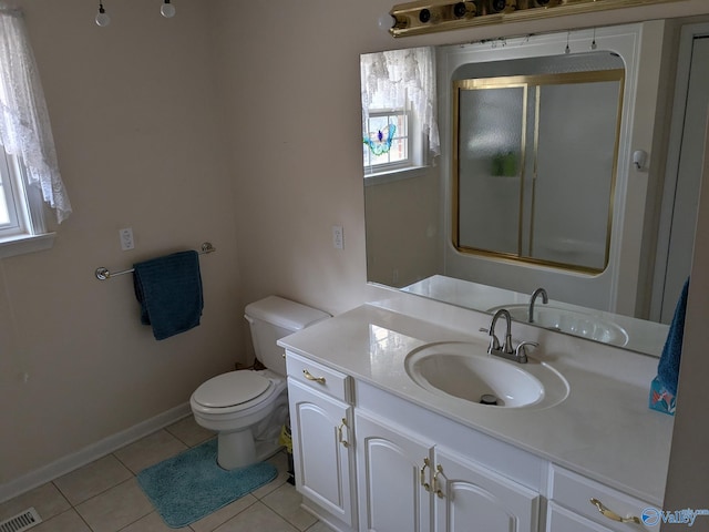 full bathroom with toilet, a shower with shower door, vanity, visible vents, and tile patterned floors