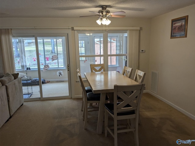 dining room featuring light colored carpet, visible vents, and baseboards