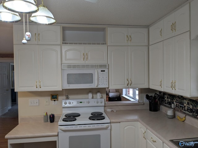 kitchen featuring light countertops, hanging light fixtures, white cabinets, a textured ceiling, and white appliances