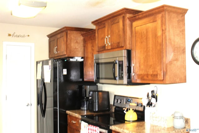 kitchen with brown cabinetry and appliances with stainless steel finishes