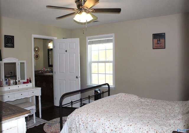 bedroom featuring connected bathroom, a ceiling fan, and dark wood finished floors