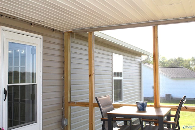 sunroom featuring outdoor dining space