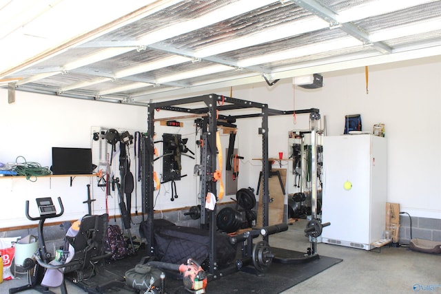 garage featuring freestanding refrigerator and a garage door opener