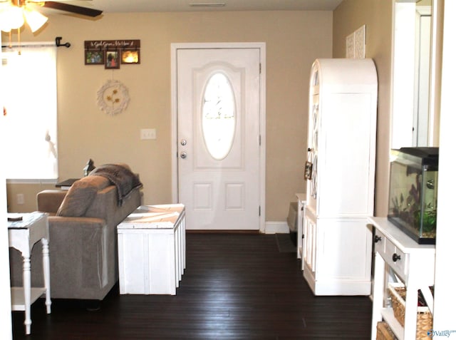 entrance foyer with a ceiling fan, baseboards, and dark wood-style floors