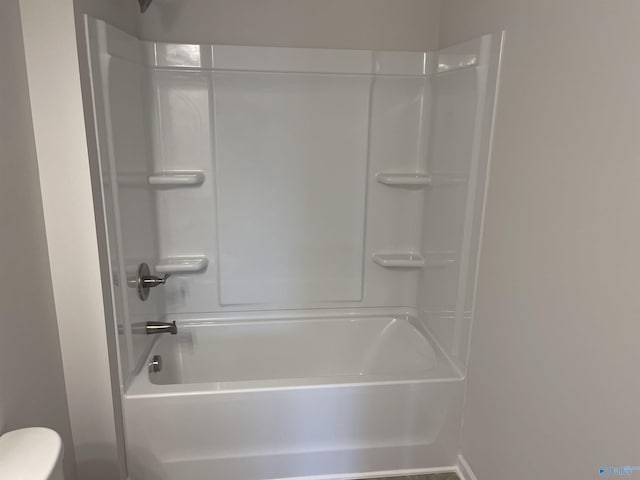 bathroom with toilet and bathtub / shower combination