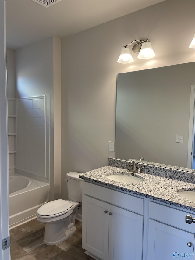 full bathroom with vanity, hardwood / wood-style floors, shower / tub combination, and toilet