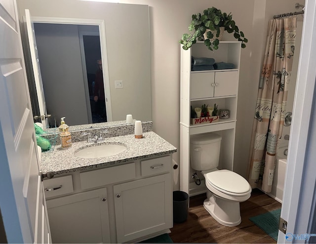 full bathroom with vanity, hardwood / wood-style flooring, toilet, and shower / bath combo