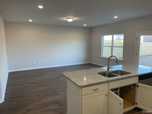 kitchen featuring sink, dark wood-type flooring, dishwasher, light stone counters, and white cabinets