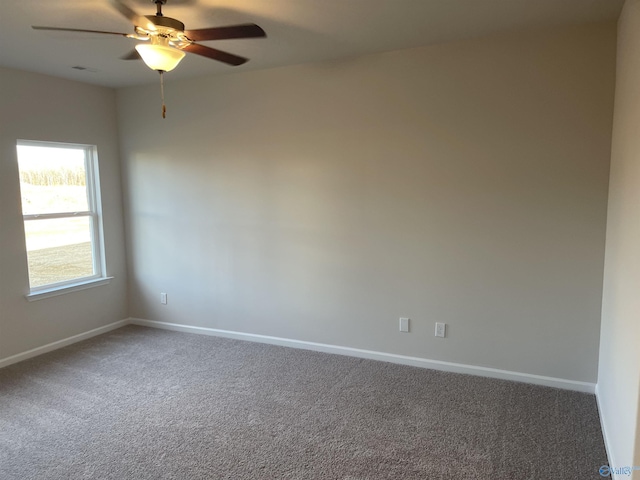 empty room with ceiling fan and carpet floors