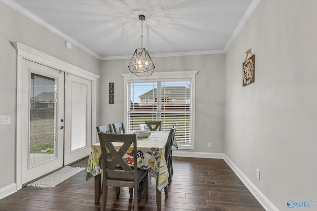 dining space featuring baseboards, dark wood-style flooring, crown molding, french doors, and a chandelier